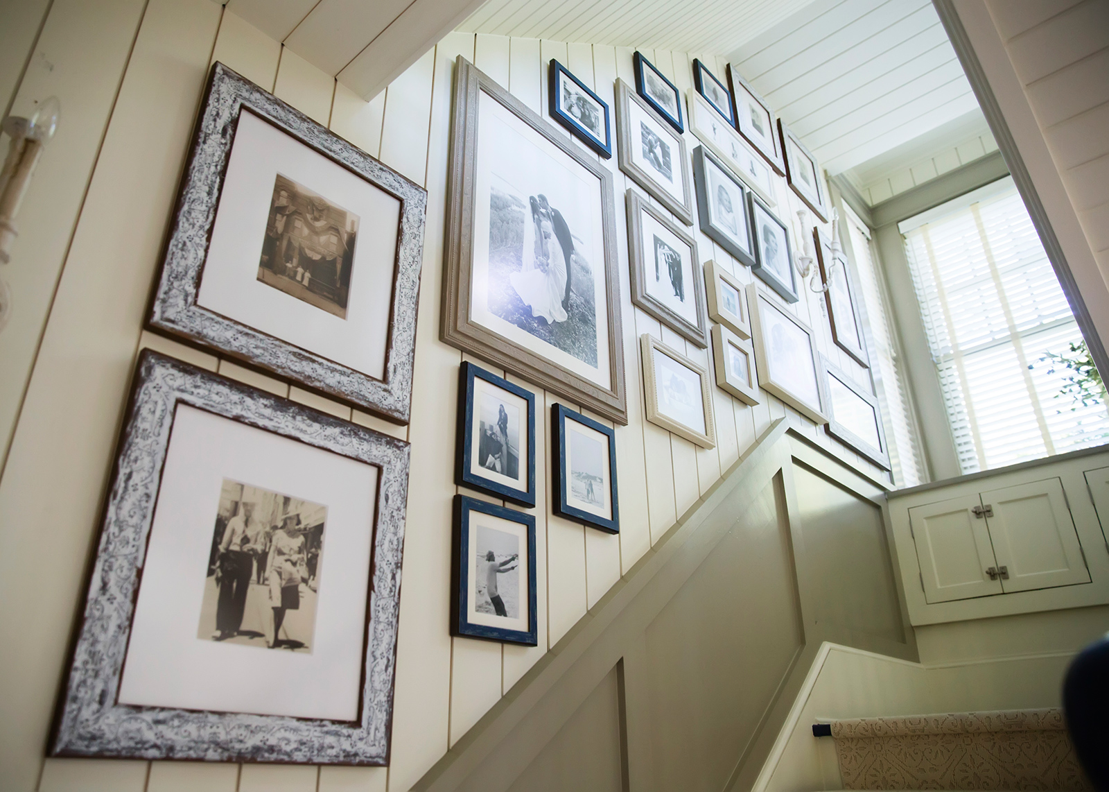Family memories are created with artfully hung portraits. In this gallery some original pictures date back to the 1860’s. Design Thought: To achieve a historical gallery like this, try to interview older living relatives and friends. Collect as many pictures as possible and choose the ones that have the most meaning. Reprint them in black and white (or sepia tones) lay the framed pictures on the floor before hanging and arrange and re-arrange the sizes and shapes until satisfied. Before nailing any holes, trace around each picture on kraft paper, then cut out. Use painter's tape to hang each cutout. Re-arrange until you find a look that you love. Keep small groups of like frames together to form some symmetry. Mix sizes and shapes for an interesting look. Keep matting the same for identical frames. Blend in an accent color on smaller 5x7 frames to add some allure that beckons shades from other areas of the home. 