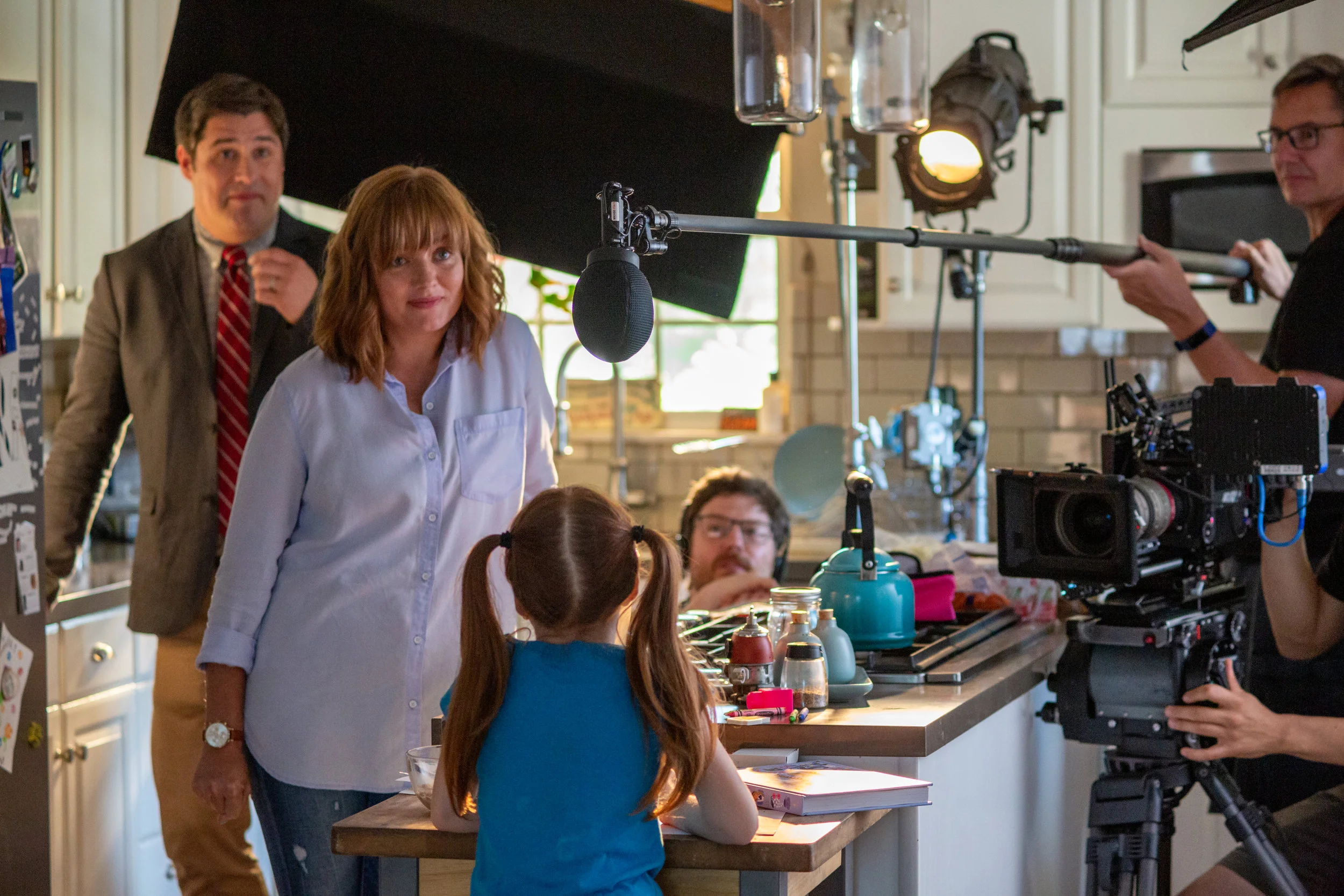 The crew shoots a family scene around the kitchen.