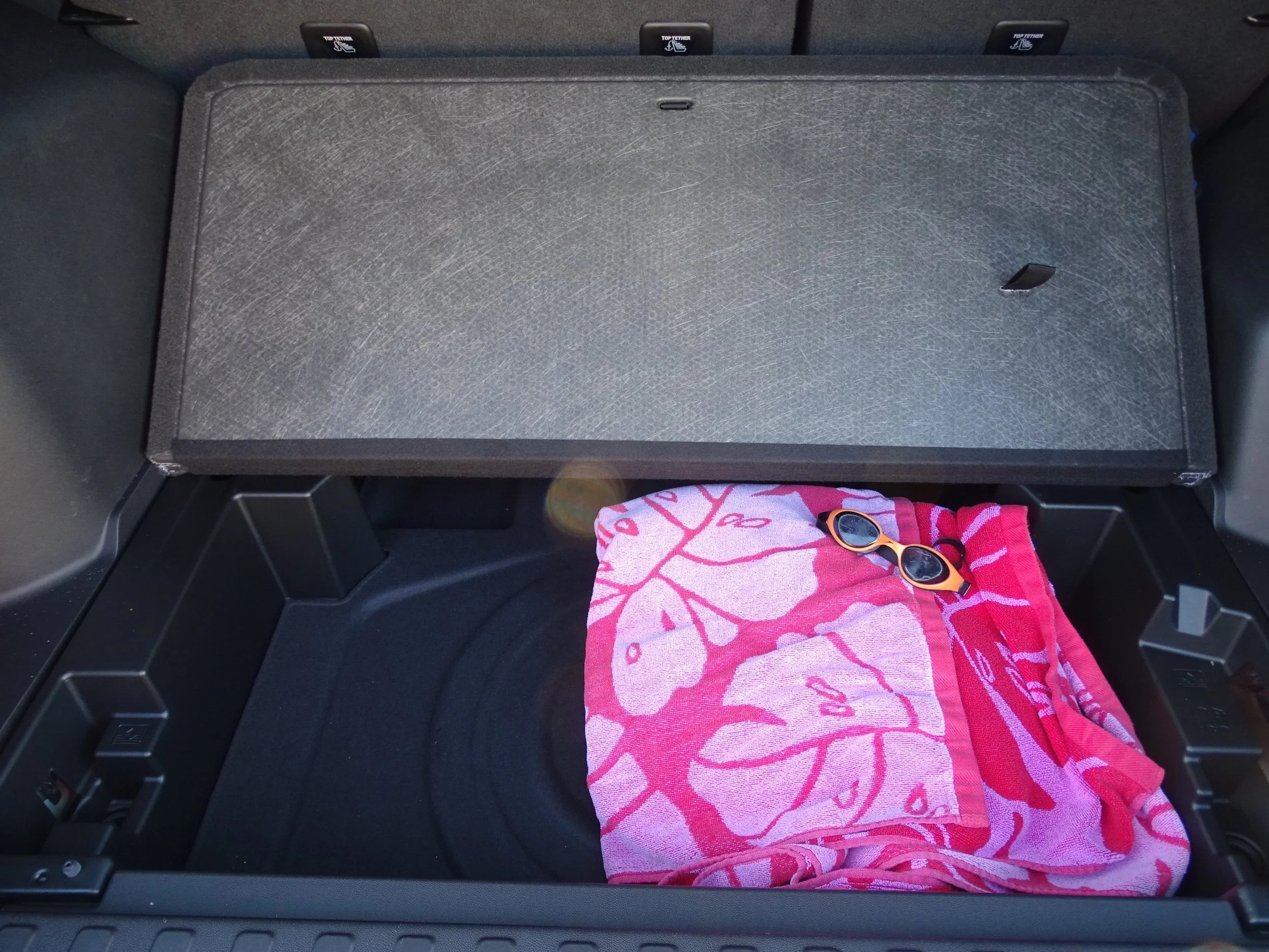 Secret storage compartment in the trunk, currently holding pool supplies, will be put to good use on future road trips.