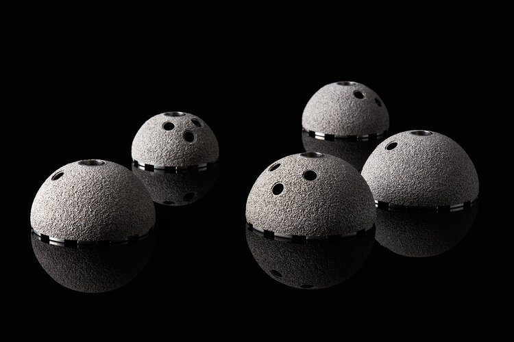 Acetabular cups, which are part of total hip replacement, showing Himed’s patented porous MATRIX Ti™ surface coating — a highly cost-effective alternative to vacuum-applied titanium.