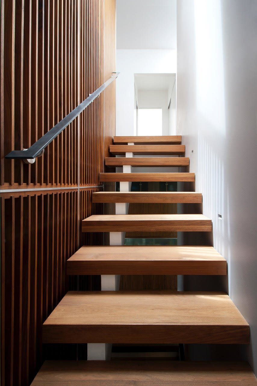 solid-walnut-slabs-were-used-for-the-interior-stair-treadsa-beautiful-and-durable-choice-sunlight-from-a-skylight-above-filters-through-the-space-creating-delicate-patterns-of-light-and-shadow-as-it-passes-through-the-screen.jpg