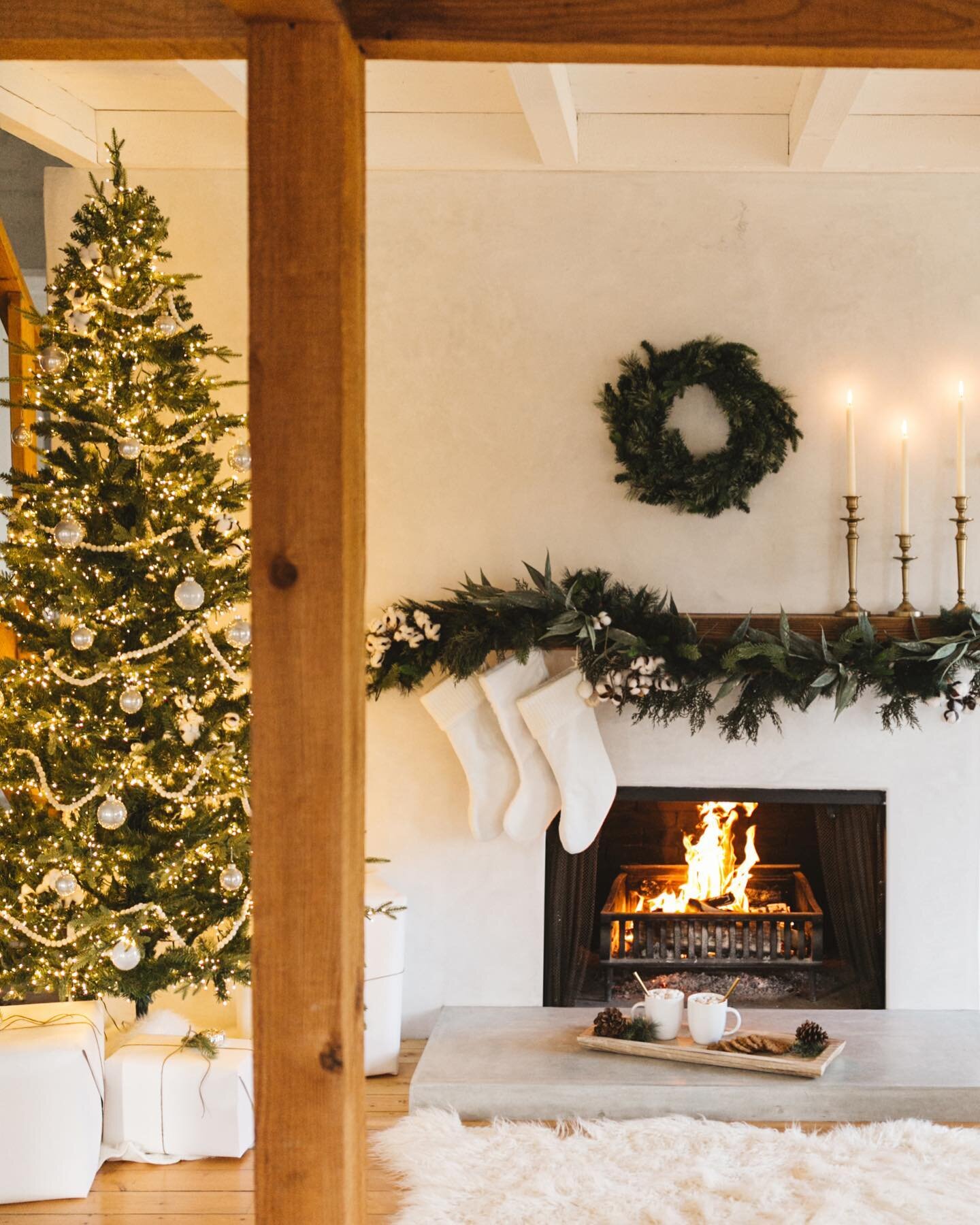 Christmas came early to the Westby home and we are not mad about it.✨ #Sponsored Everything from the magical tree, cozy rug, gold candle stick holders, garlands, wreaths, stockings, ornaments, and wood tray are all from @athomestores . They have one 