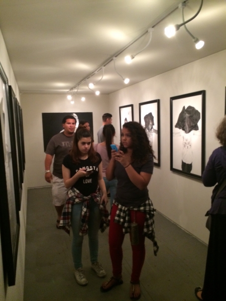  People enjoying Rigo's drawings, First Friday, 4-3-15. Photo credit - Ted Decker 