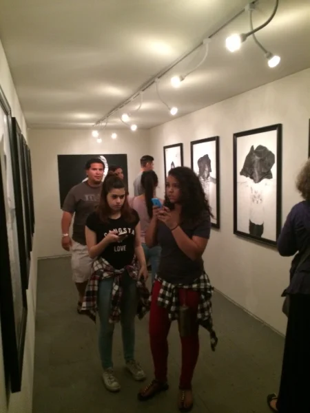 People enjoying Rigo's drawings, First Friday, 4-3-15. Photo credit - Ted Decker