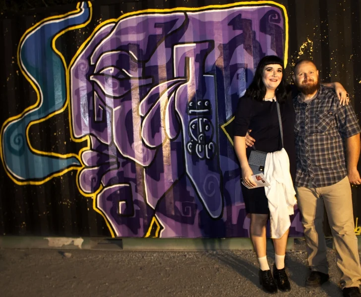    Kelsey Duff and Cory Slawson in front of Edgar's mural, Third Friday, 10-16-15. Photo credit - Ted Decker   