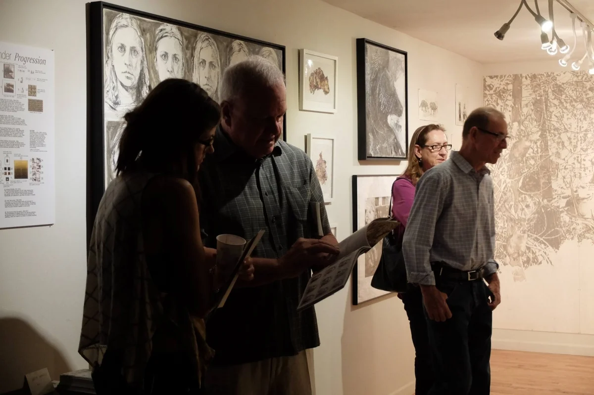 Viewers at Carolyn Lavender's exhibition, 3-18-16. Photo credit Salman Alwastey. Photo credit: Ted Decker