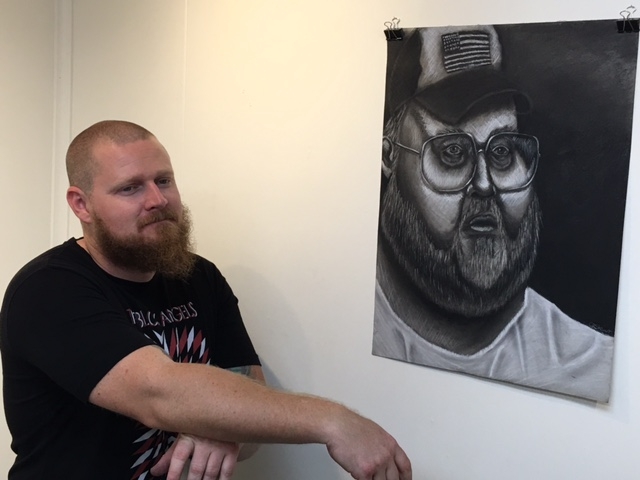  Cory Slawson, phICA's Logistics Manager, hanging a Christian Stewart drawing, 4-16-16 
