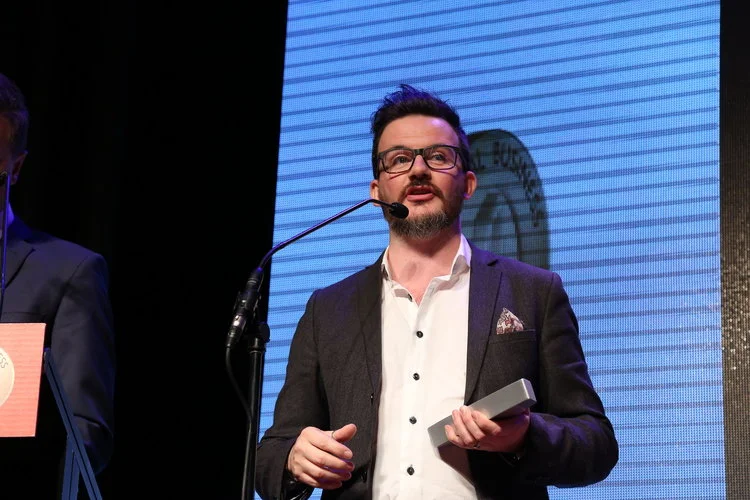 John accepting the outstanding specialised business award