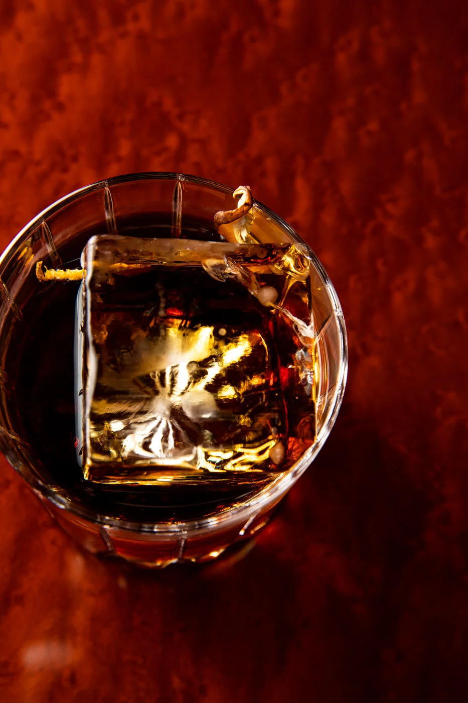 Dark cocktail with a carved piece of ice served at the Four Seasons Otemachi