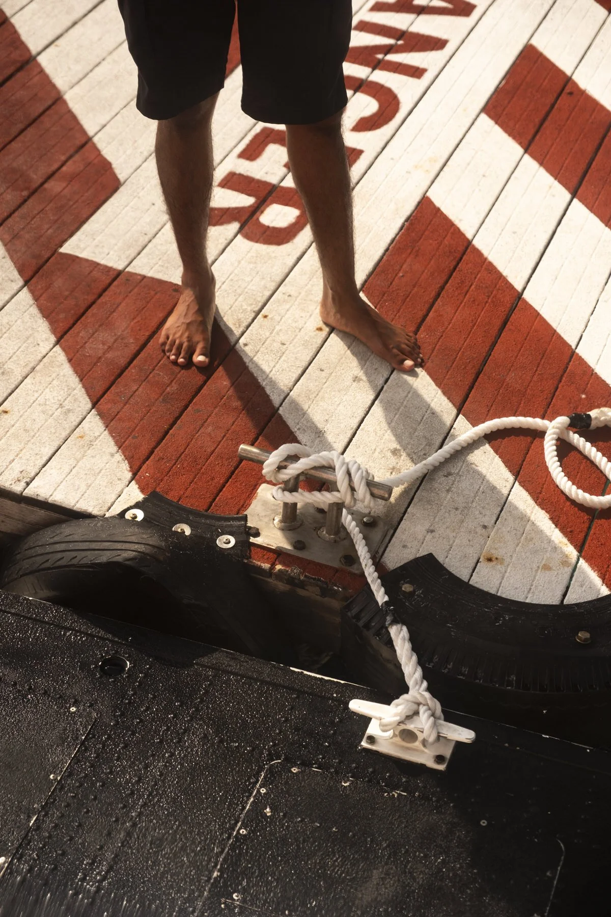 Pilot of a seaplane stands on a dock in the Maldives