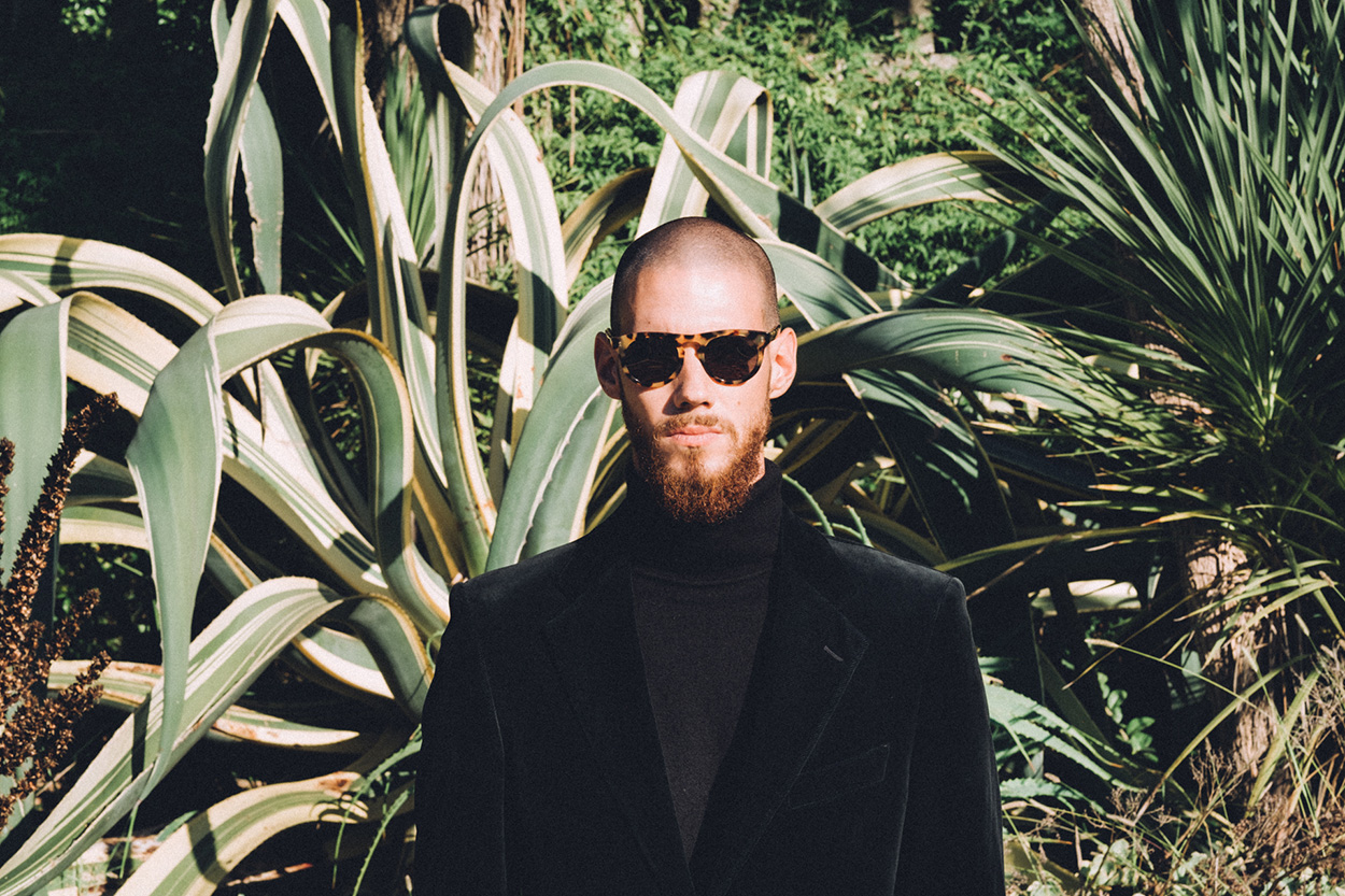 Darkside Eyewear Corvus Amber sunglasses in the garden