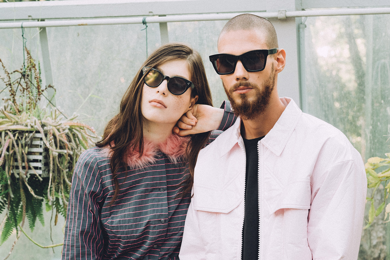 Darkside Eyewear Rhea and Draco in Black sunglasses in the garden