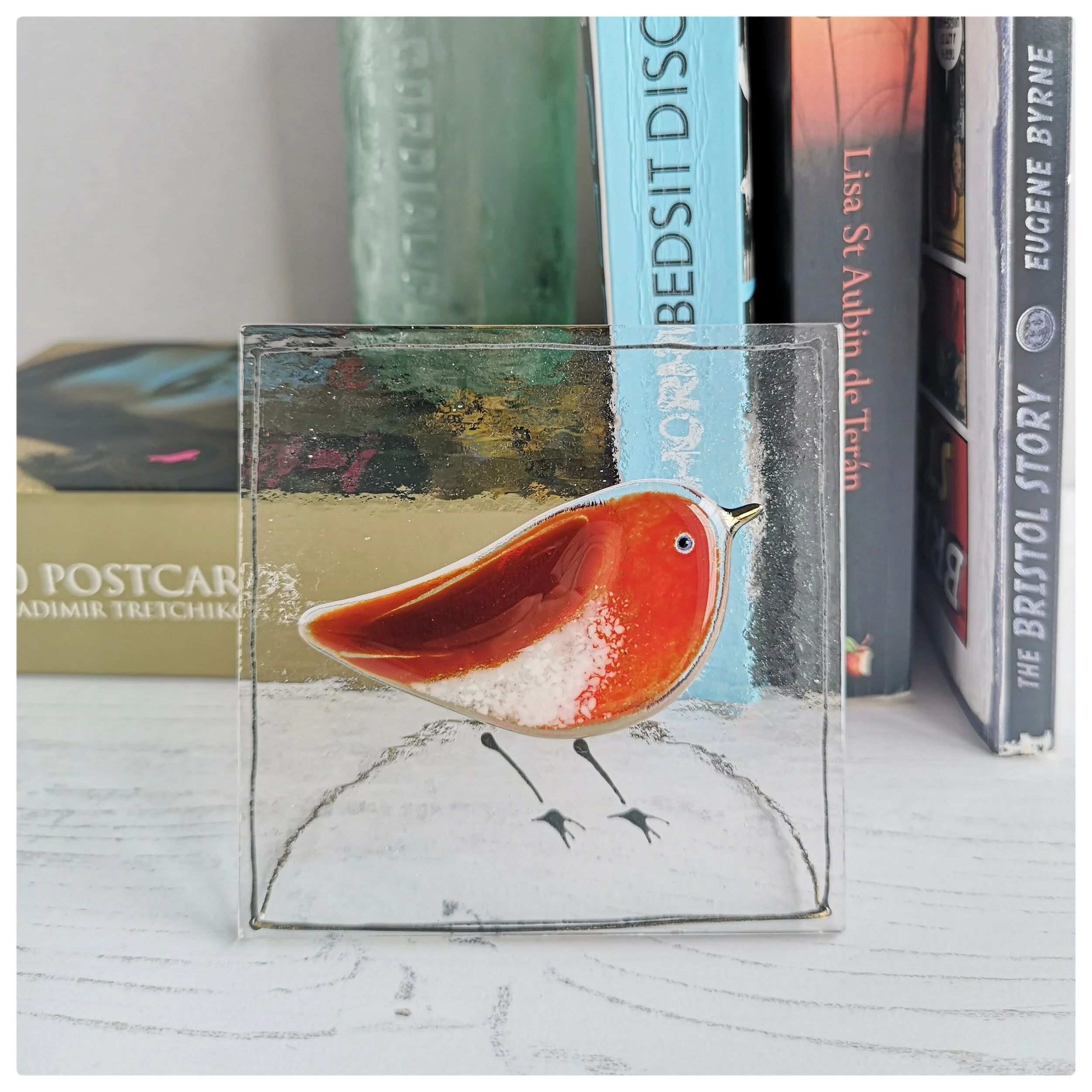 a fused glass robin plaque with a discreet wire stand by Robyn Coetzee-Glass Designs