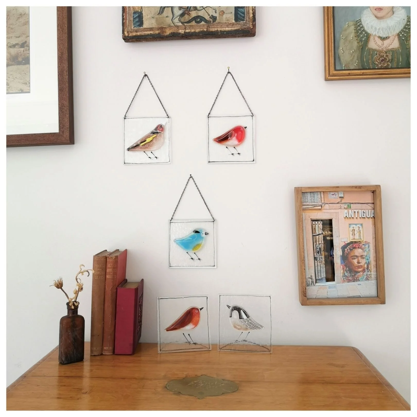 view of hanging and standing glass plaques including goldfinch, robin blue-tit and coal-tit variations
