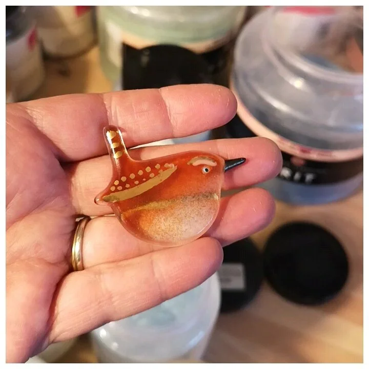 glass wren held in a hand