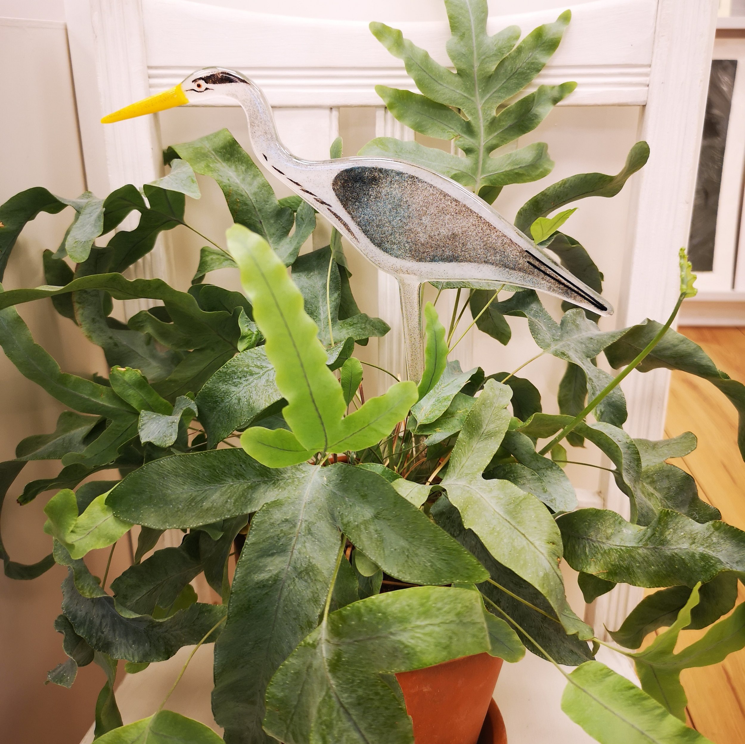 A handmade fused glass heron decoration