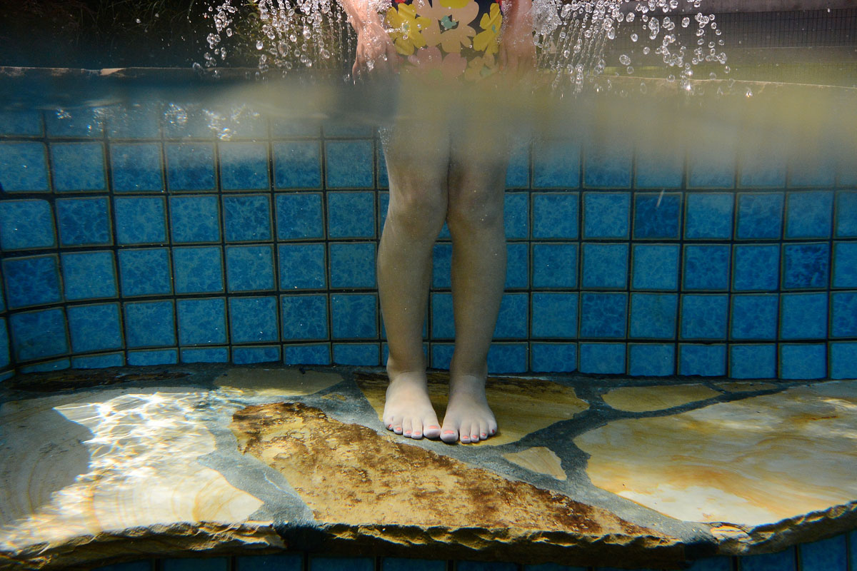 young girl plays in New Jersey swimming pool fountain underwater