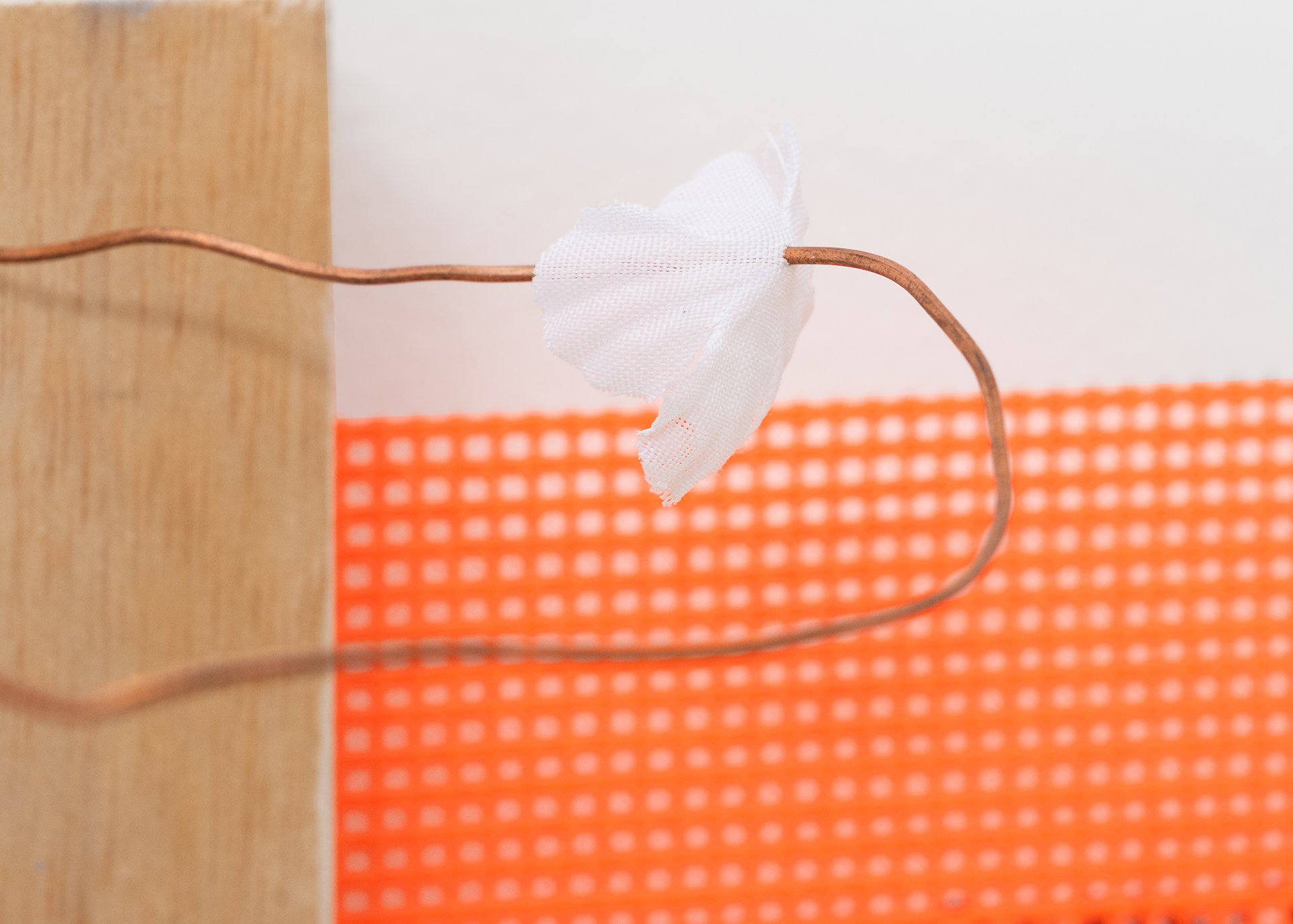    Hot Cage  , 2025 (detail) Baltic birch plywood, thermostat wire, fabric mesh, drywall scrap, foam, chalk, cardboard, artificial flower petal, vinyl lettering 10”h x 12”w x 6”d 