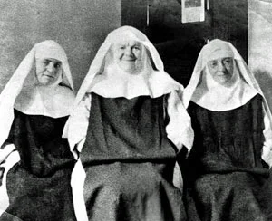 Above, Lay Sisters wearing black scapulars (Sr. Mary Rose, mentioned in Part II is in the center) while the picture below shows a group of Lay Sisters wearing white scapulars
