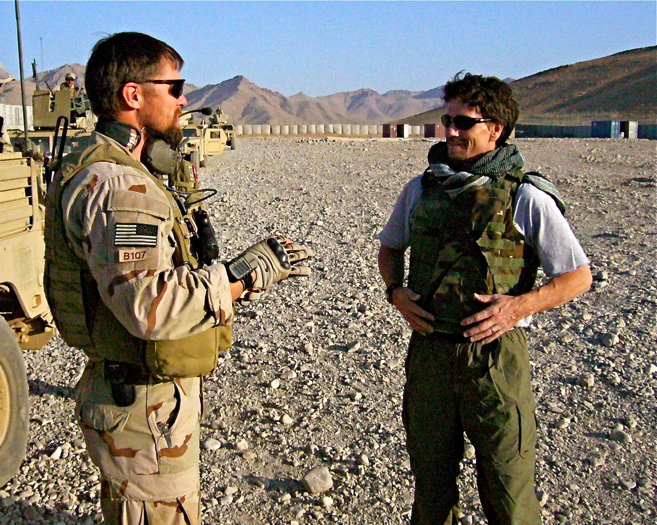 Steve Hoggard talks with Green Beret comm sergeant 'Chris' before heading outside the wire at Firebase Cobra.