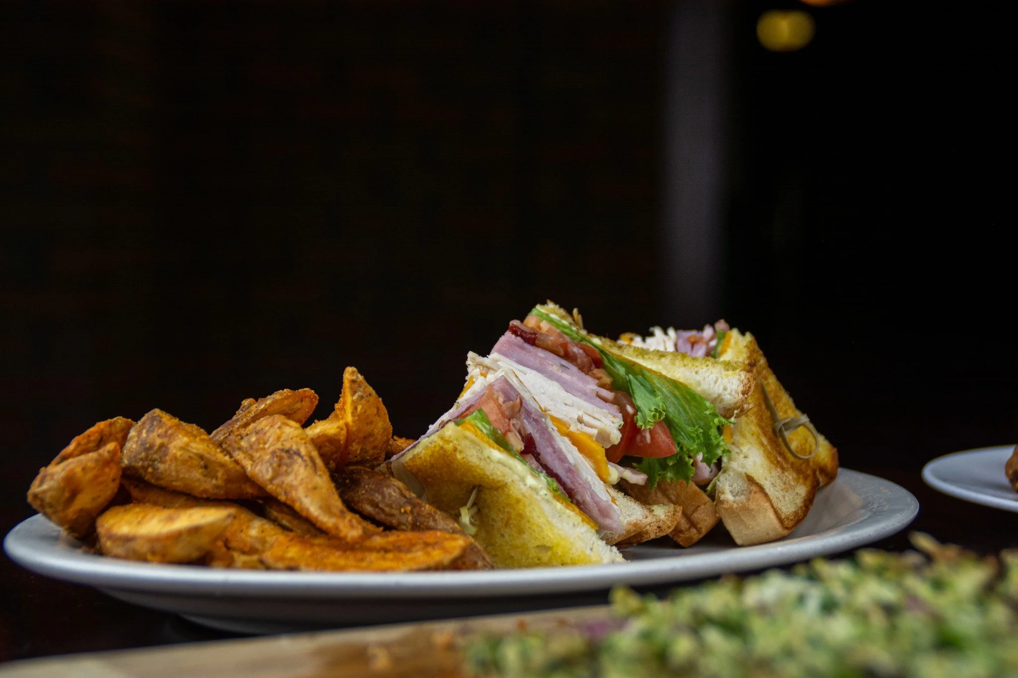 The &ldquo;Tusk&rdquo; Club Sandwich never misses! 🐗🥪 Stacked with oven-roasted turkey, honey baked ham, Applewood smoked bacon, cheddar, lettuce, tomato, and remoulade on toasted sourdough. Grab yours today at Mad Boar Restaurant &amp; Pub!

#MadB