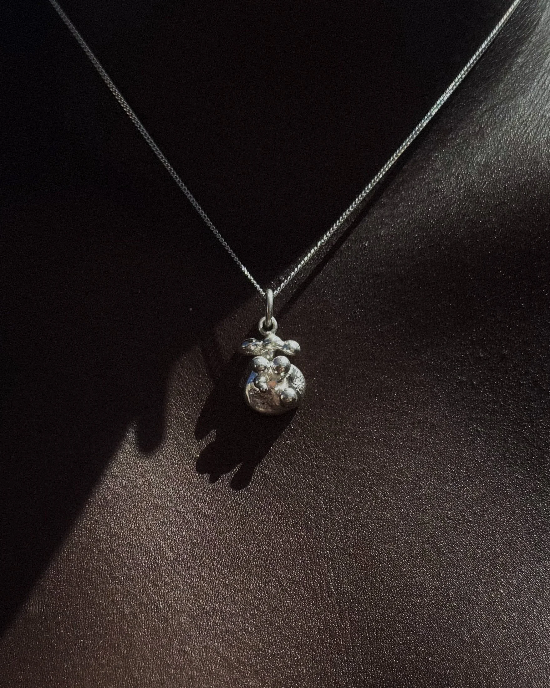 Jakhu-Moon-Drops_silver-charm-03-on-skin.jpeg