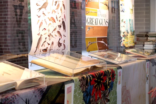  For our exhibition entitled "Long Live the Book," my classmates and I utilized the two posters in the window space in a gallery space at our college. We built fitted, plexiglass cases to contain our books in the windowsill, a perfect height for view