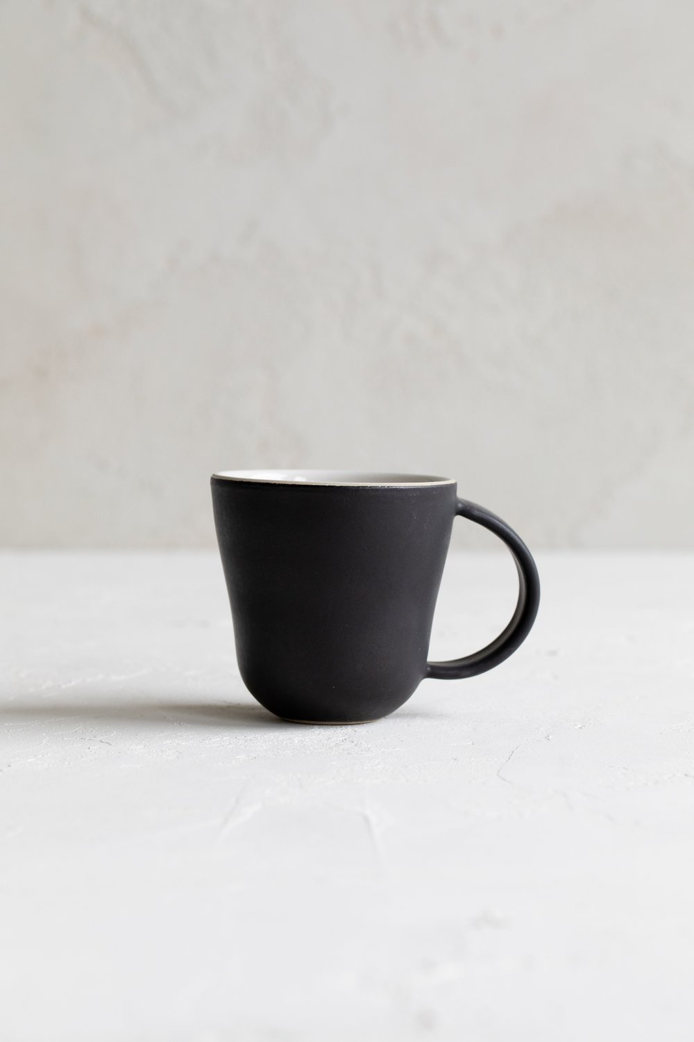 https://images.squarespace-cdn.com/content/v1/591e25c715cf7d0ce88d273e/1651688109303-QIGWKRKZE0NBQI7ZTVRL/stoneware_coffee_mug.jpg?format=1000w