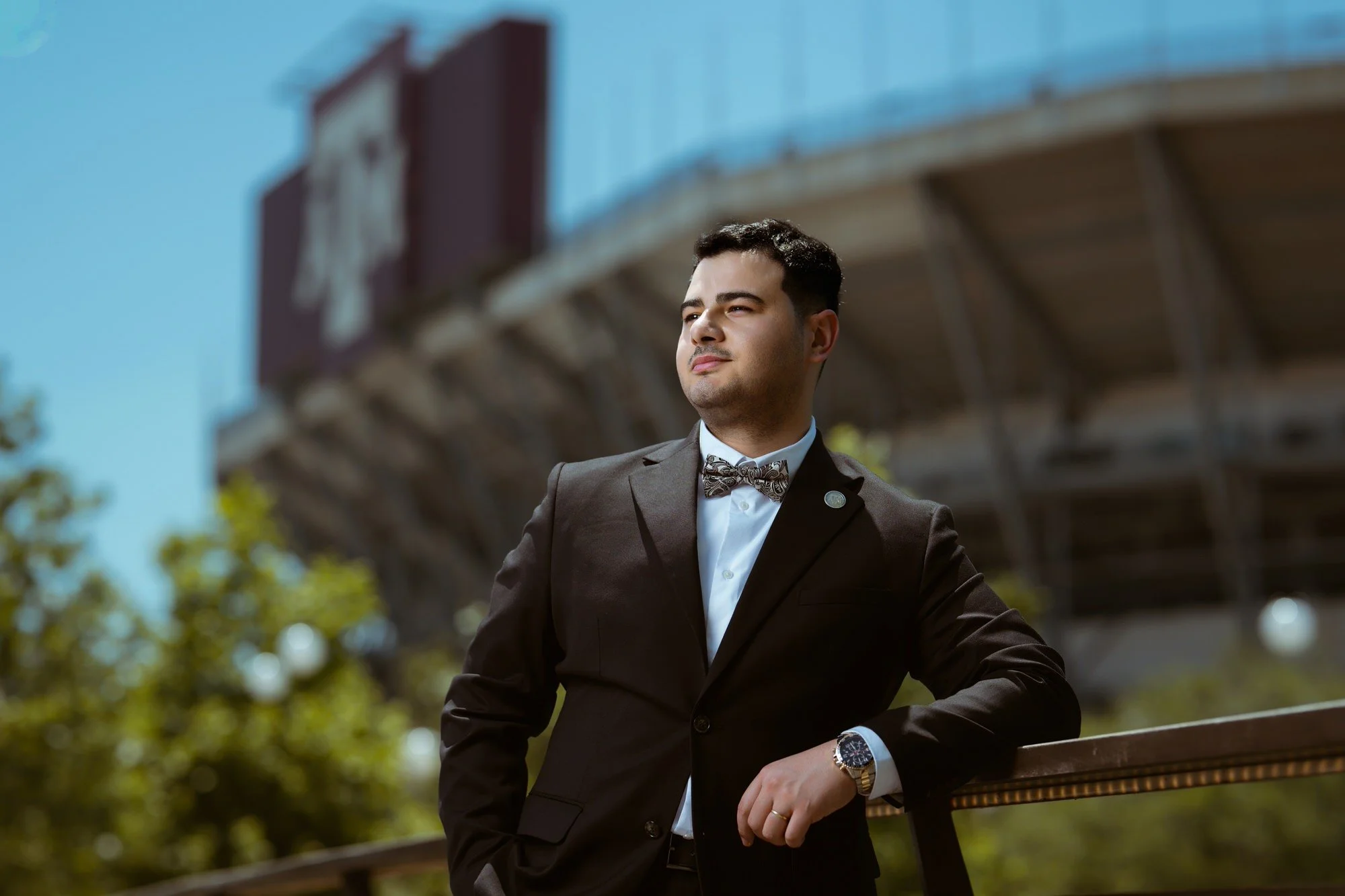  Texas A&amp;M senior portrait of man in suit and bow tie outside Kyle Field, College Station TX 