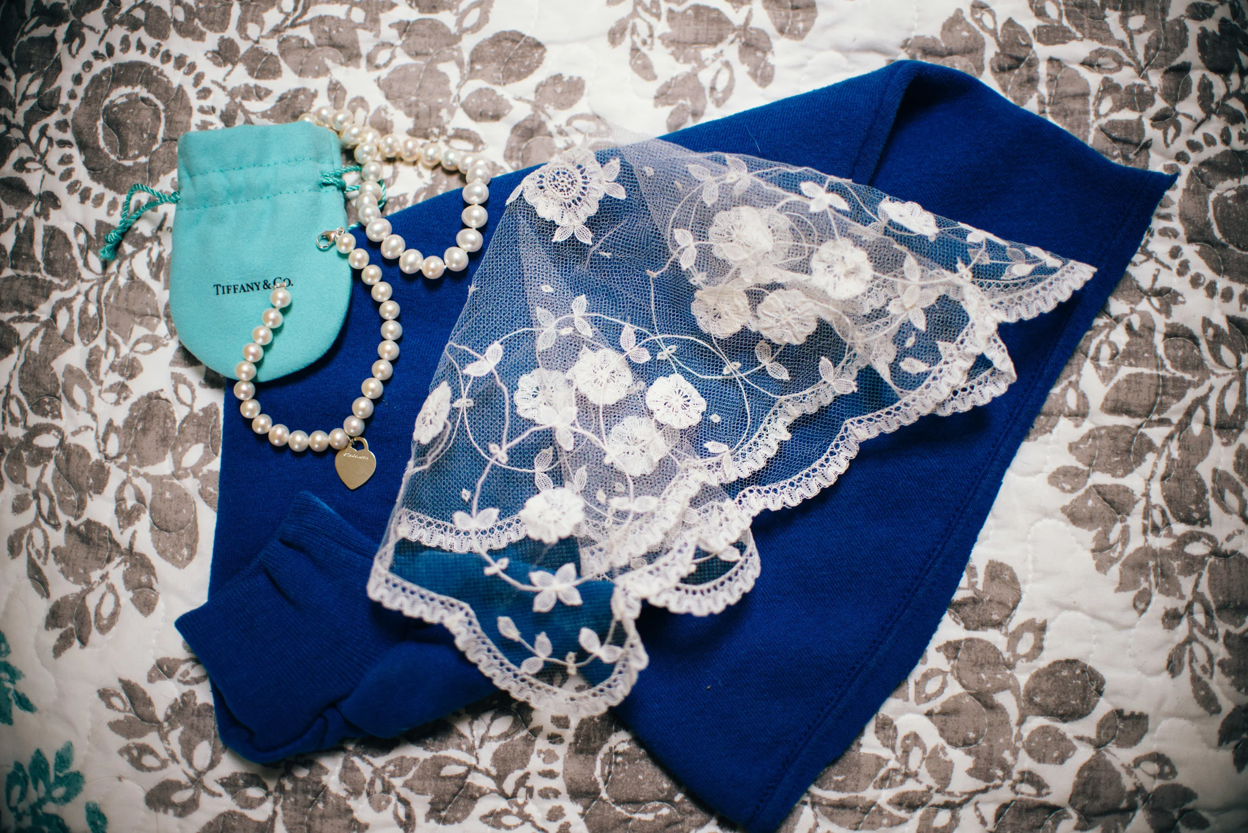 Sentimental wedding details like a sweatshirt from the bride's grandfather used as her something blue along with a lace veil from her great great grandmother.