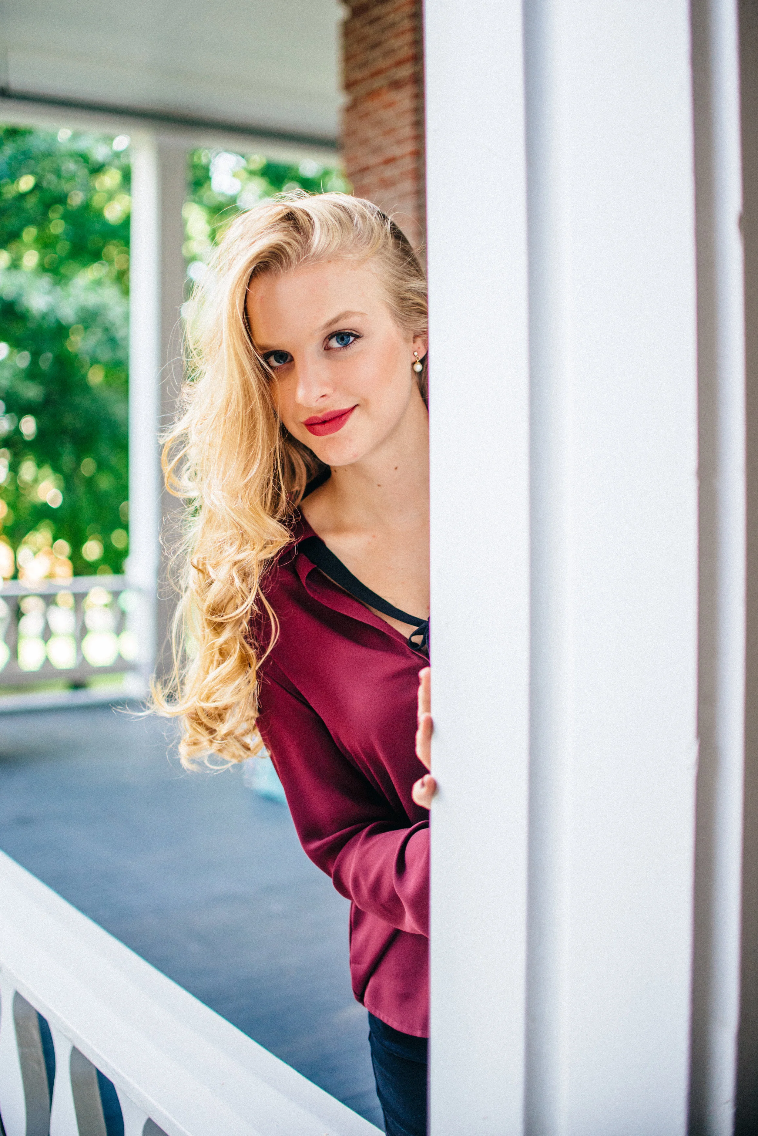 Blonde senior model with long curly hair flipped to one side
