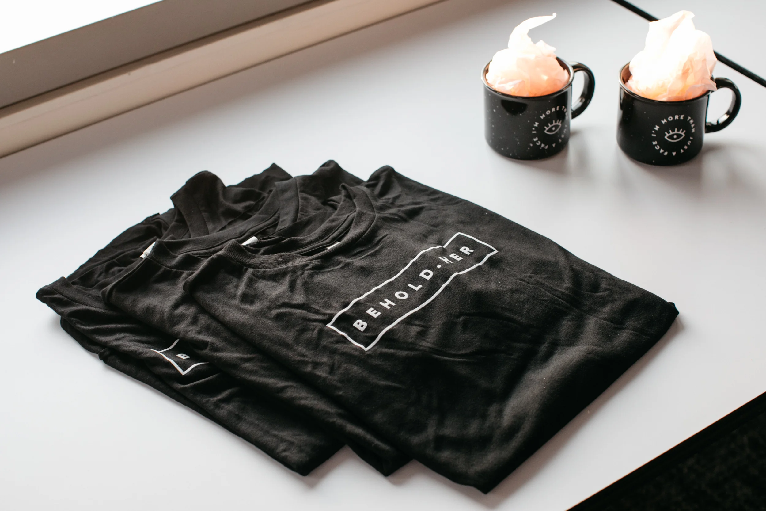 Limited edition tees and mugs that are sold exclusively at events.