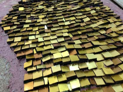 Gold tesserae angled to reflect the maximum light, viewed from above