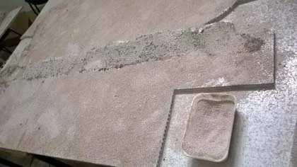 Sand is glued to the Aerolam sheets to provide a key