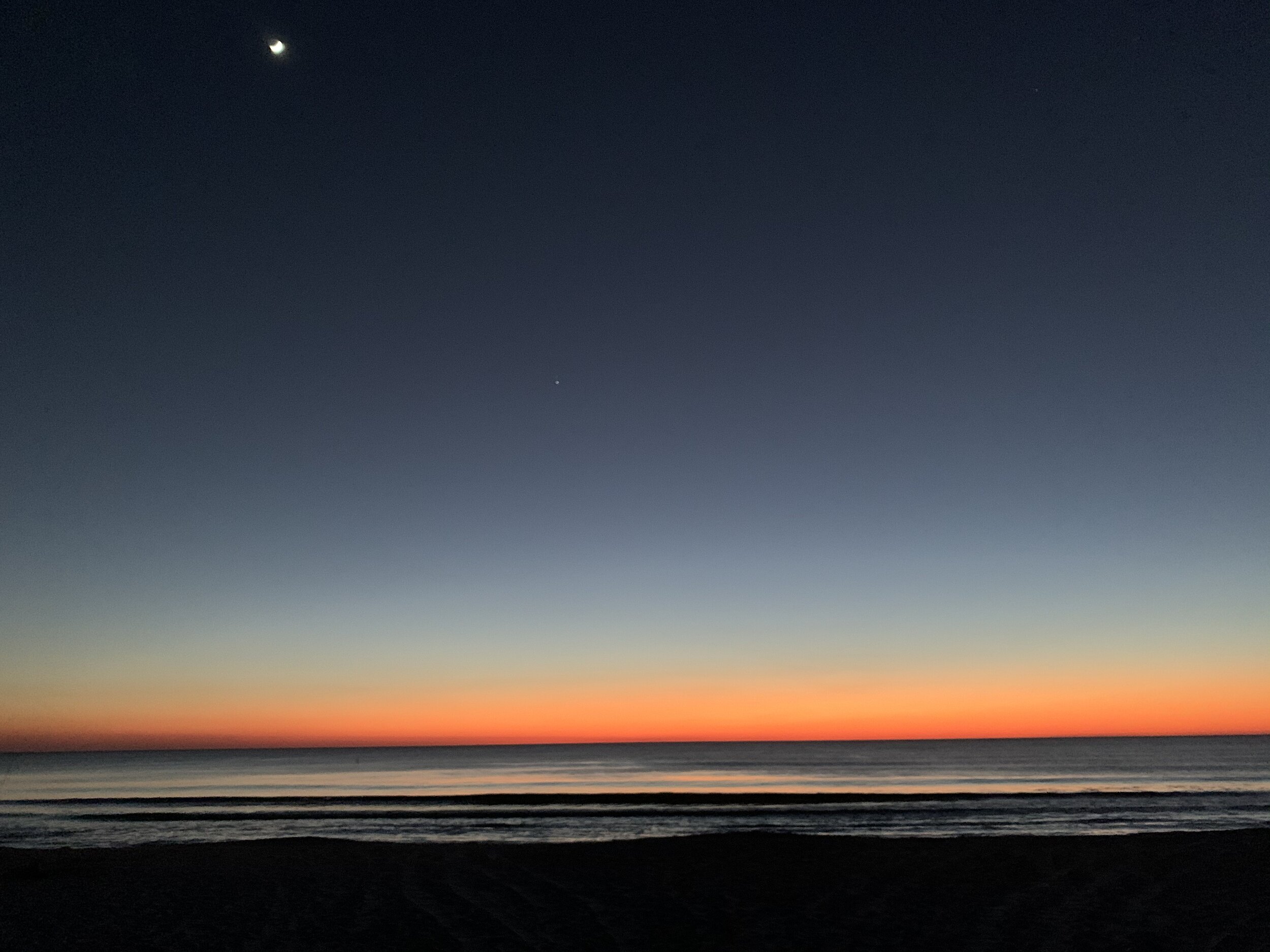 Gulf of Mexico.  Dec 18th, as the Great Conjunction begins.  Jupiter is barely visible as the sun has set. The moon in the very upper left.