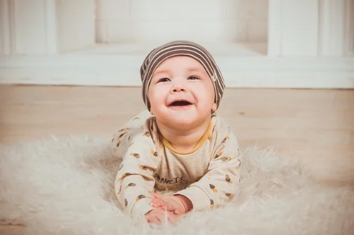 Cute baby on a rug ready to play