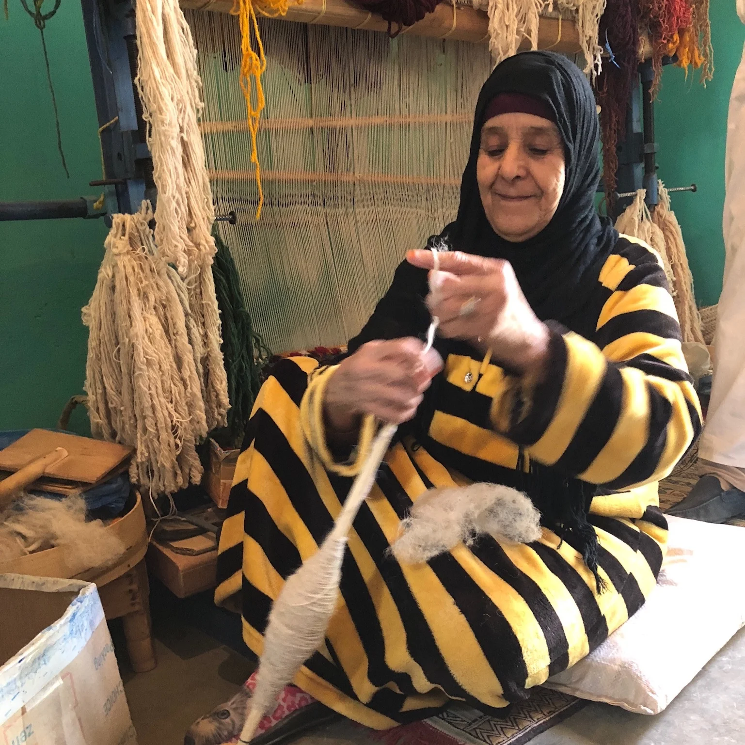 Spinning the wool, by hand.