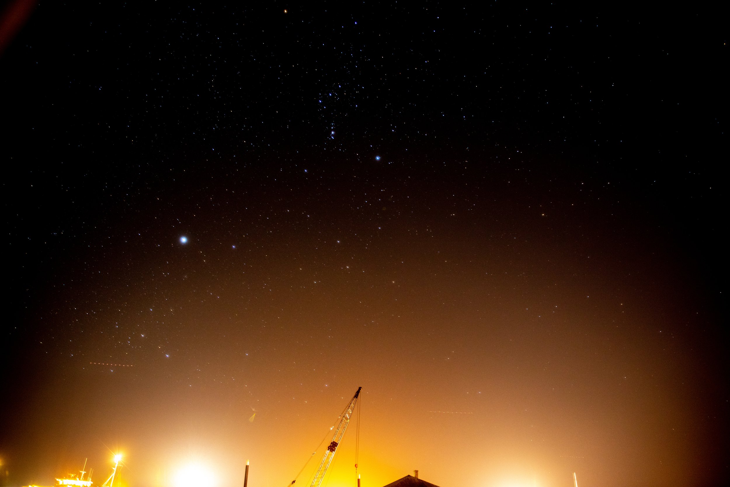 Nantucket Town at night, under constellations Canis Major (with bright star Sirius) and Orion (top center)