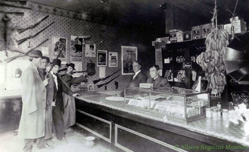 Interior of Clifford Walker's General Store and Shooting Gallery, 400 block of West First Avenue, c. 1914. Clifford later became a long time Albany florist: his father, Cyrus, was the first white, male child born west of the Mississippi.