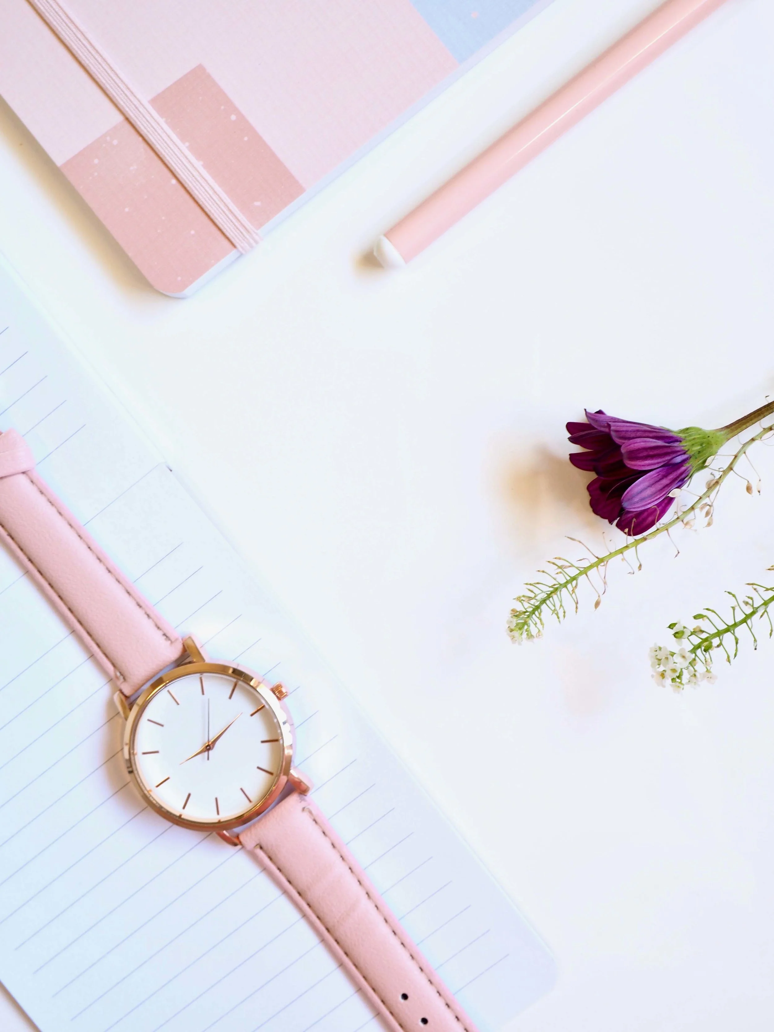 Watch and flowers in pink and purple.