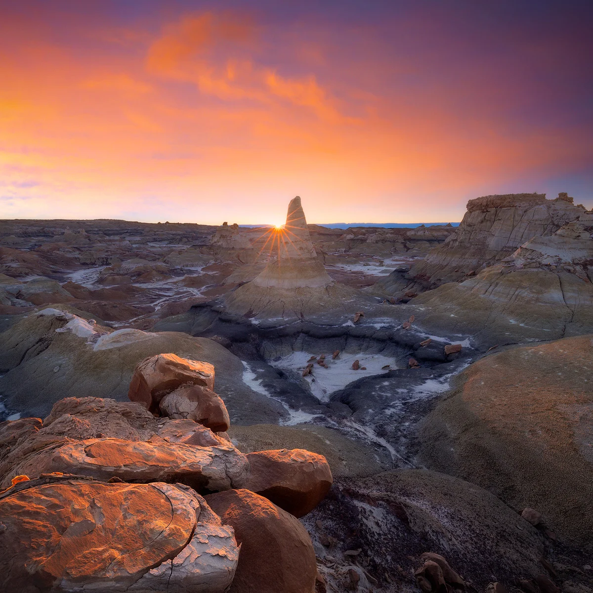 A fantastic birds-eye view of a small pit of boulders deep in the wilderness of New Mexico's Bisti Badlands at sunset.