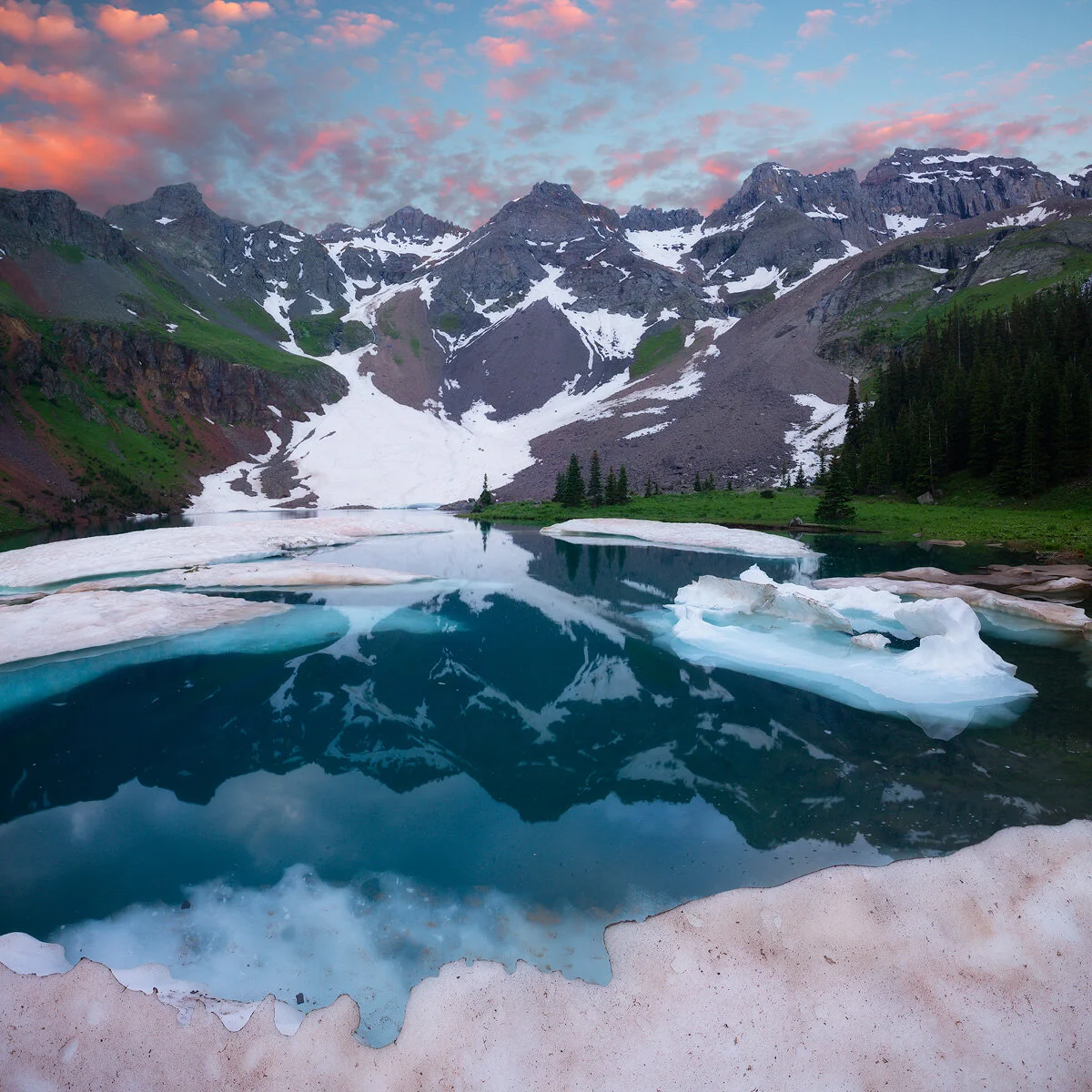 Don't be surprised to find snow amongst the wildflowers of summer while backpacking Colorado's Blue Lakes.