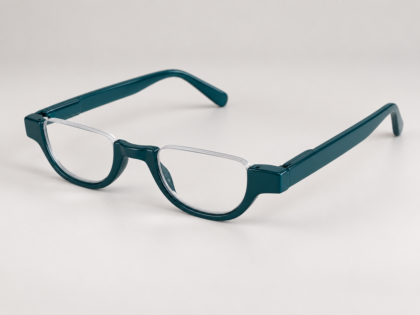 Cove teal half-eye reading glasses viewed at an angle, showing the open-top lenses and glossy teal arms