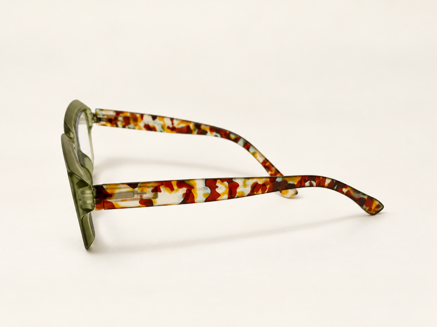 Side view of Ikaly Seoul reading glasses showing the translucent green frame and patterned temples