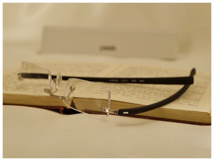 Pair of rimless reading glasses with silver coloured nose-bridge