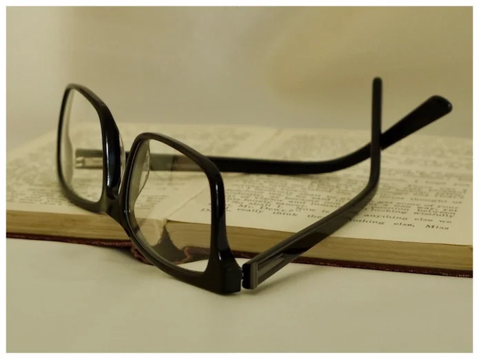 glass lenses, black plastic spectacle frames