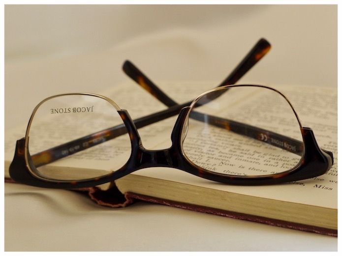 pair of women's spectacles on a thomas hardy novel