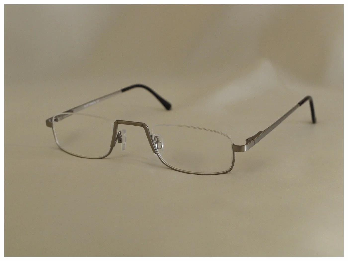 pair of metal half-eye reading glasses, in an antique pewter colour