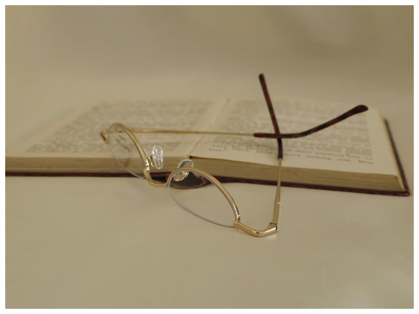 half-moon, gold coloured spectacle frame.
