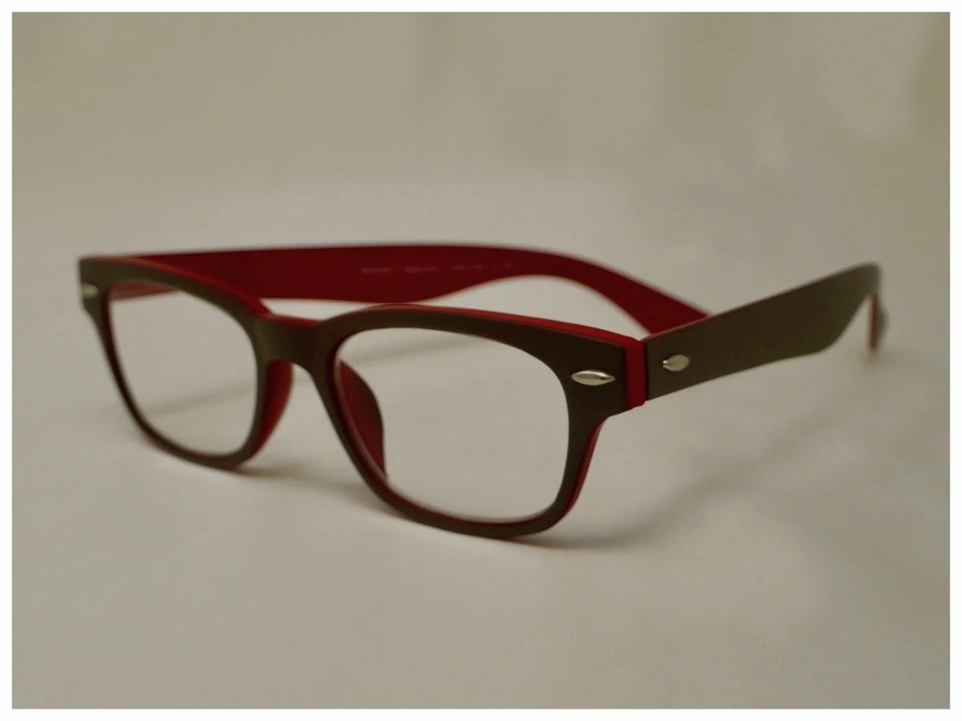 pair of reading glasses in grey and red